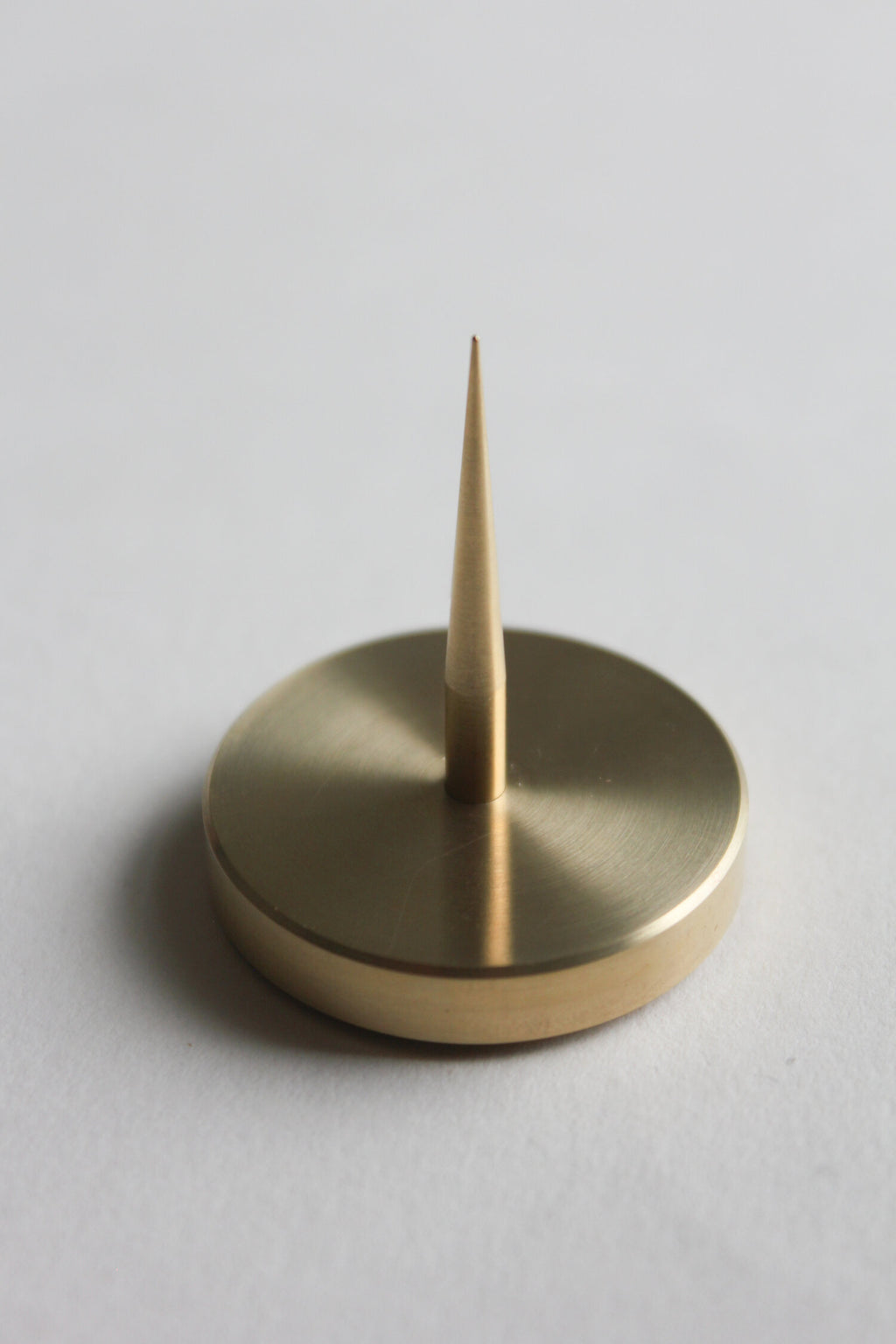 Close up of solid brass spike candle holder