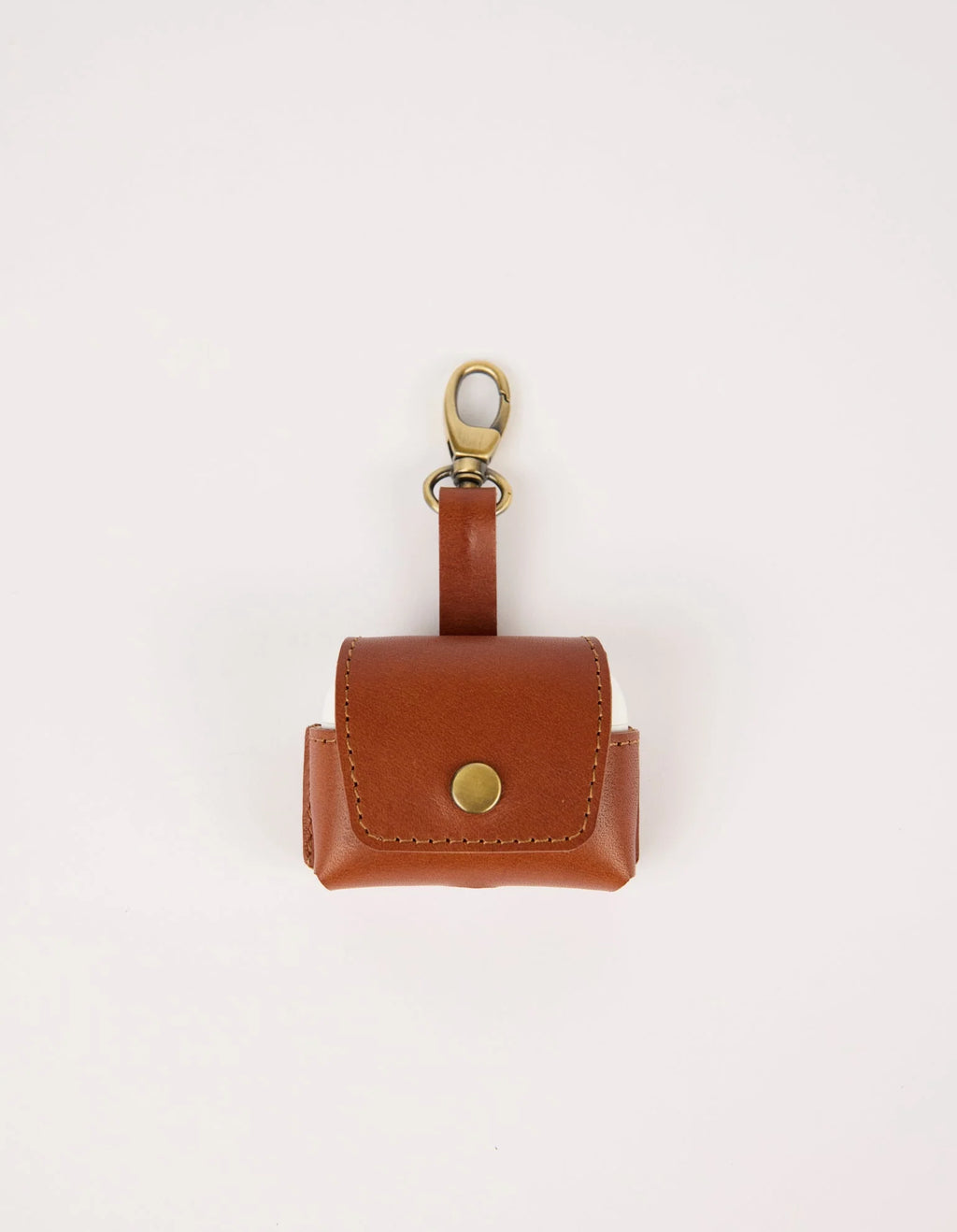 Brown leather keychain pouch with gold accent on a light beige background