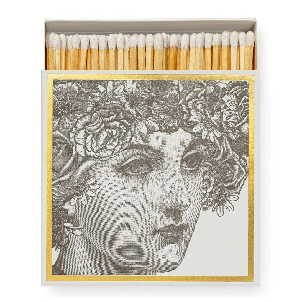 box of matches with an ornate, vintage-style illustration of a woman's face adorned with a floral wreath