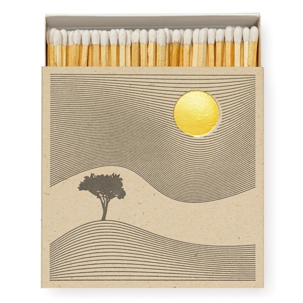 Psychedelic looking sun and tree landscape on matchbox