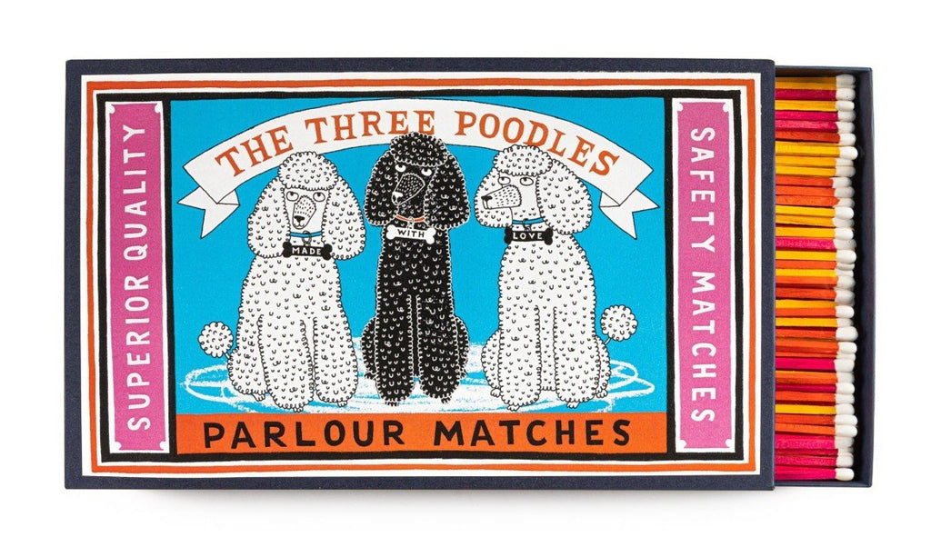 A matchbox with three dogs that says "The Three Poodles Parlour Matches"