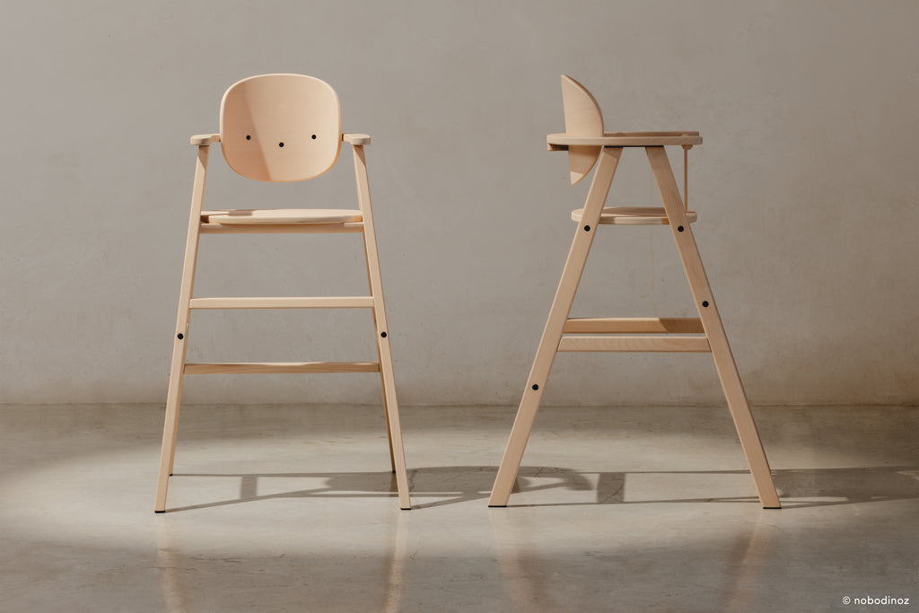 A front and profile shot of the wooden high chair