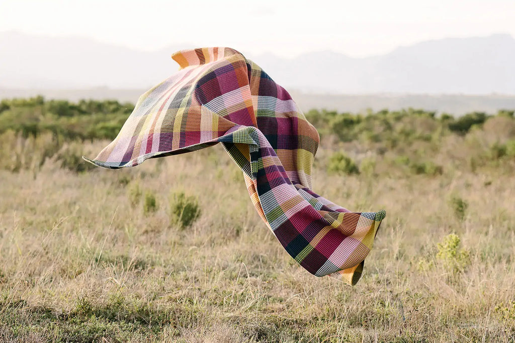 Vrou 100% cotton blanket blowing in a field.
