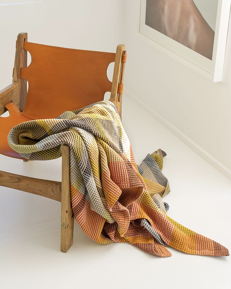 A Mungo blanket draped on chair