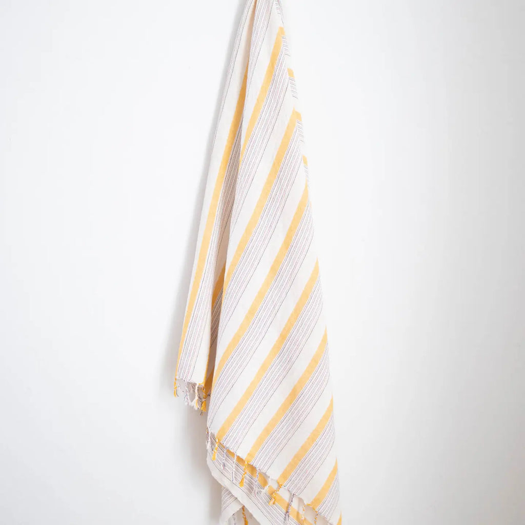 Striped fabric with yellow and white pattern on a white background