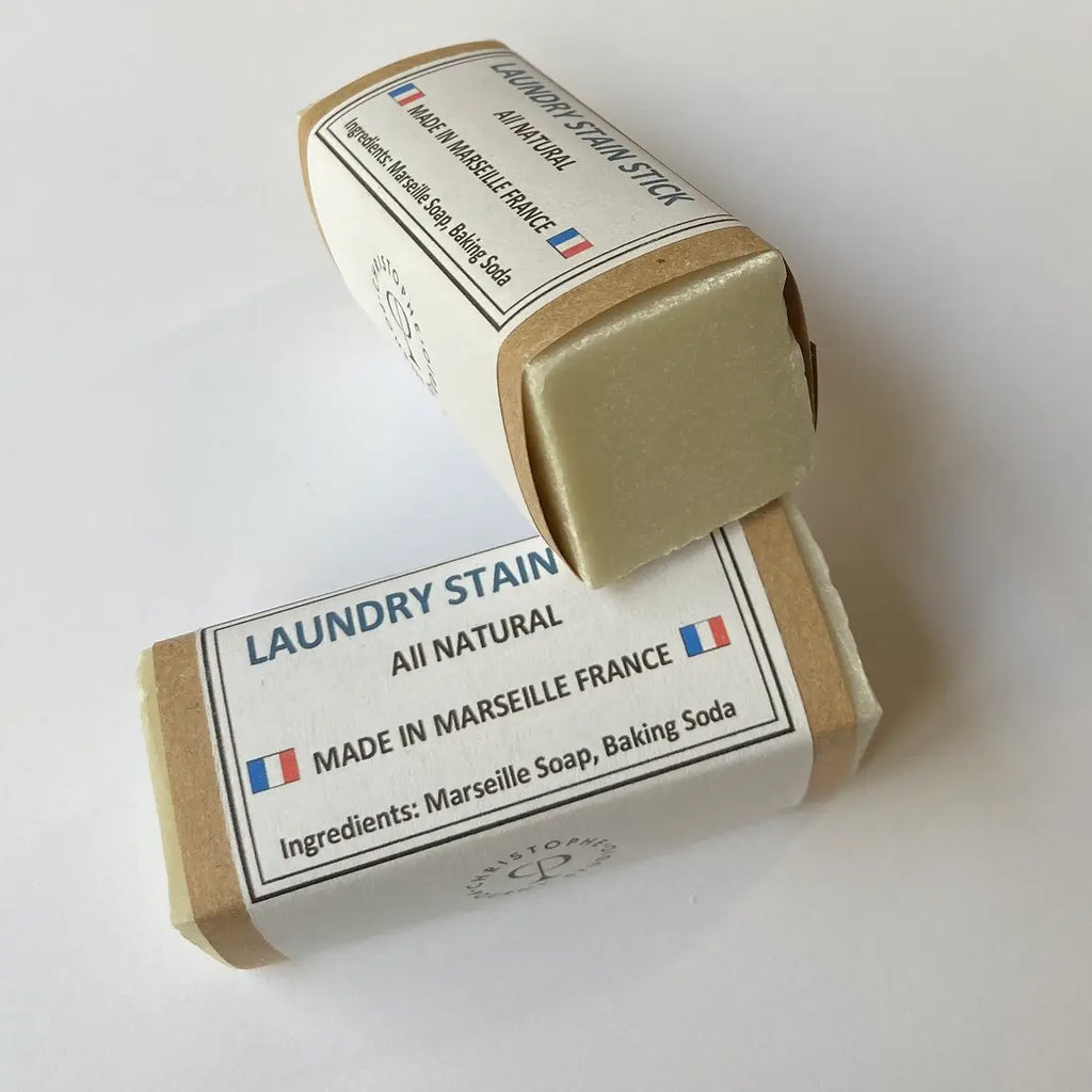 A packaged laundry stain stick labeled 'LAUNDRY STAIN REMOVAL' with text indicating it is made in Marseille France, and includes ingredients such as Marseille Soap and Baking Soda.