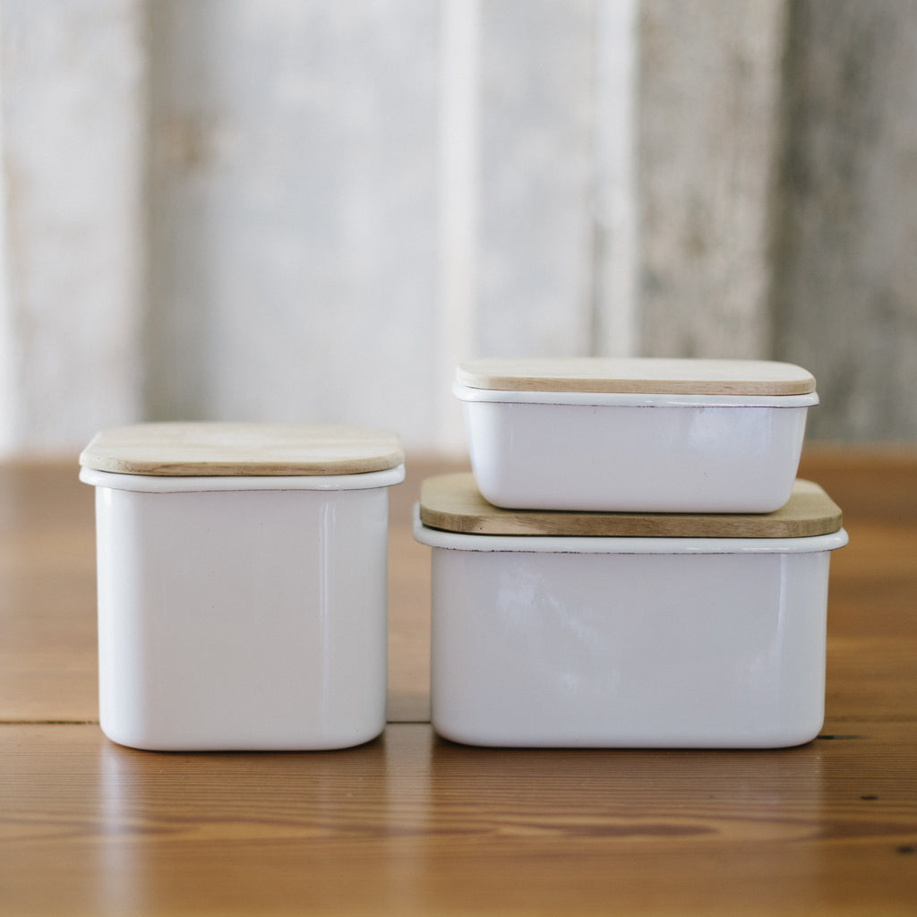 three sizes of enamel storage containers with acacia wood lids