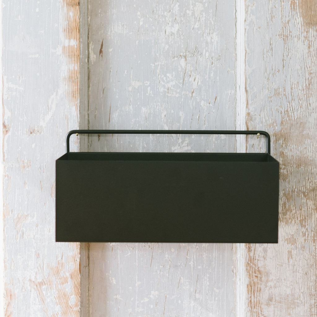 A black powder-coated planter box