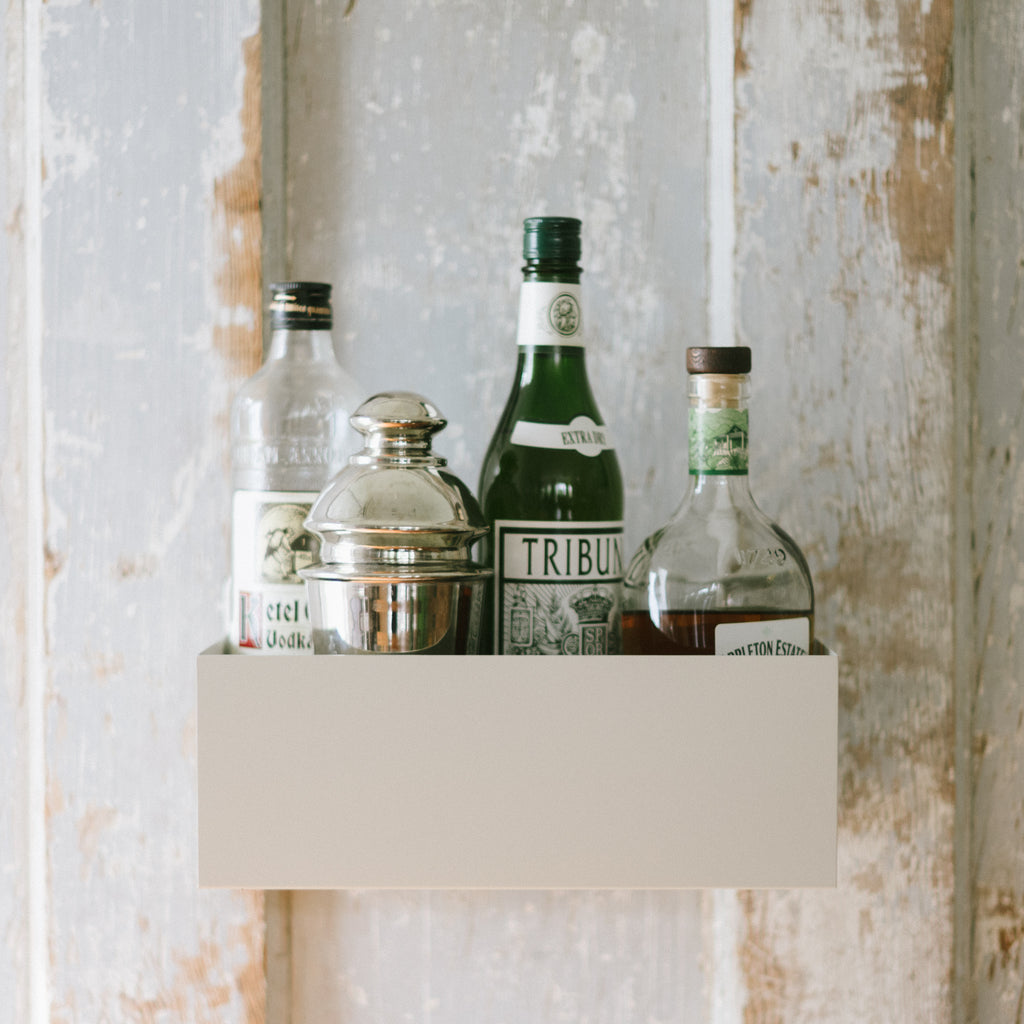 A Planter Wall Box being repurposed to hold bar and cocktail accoutrements