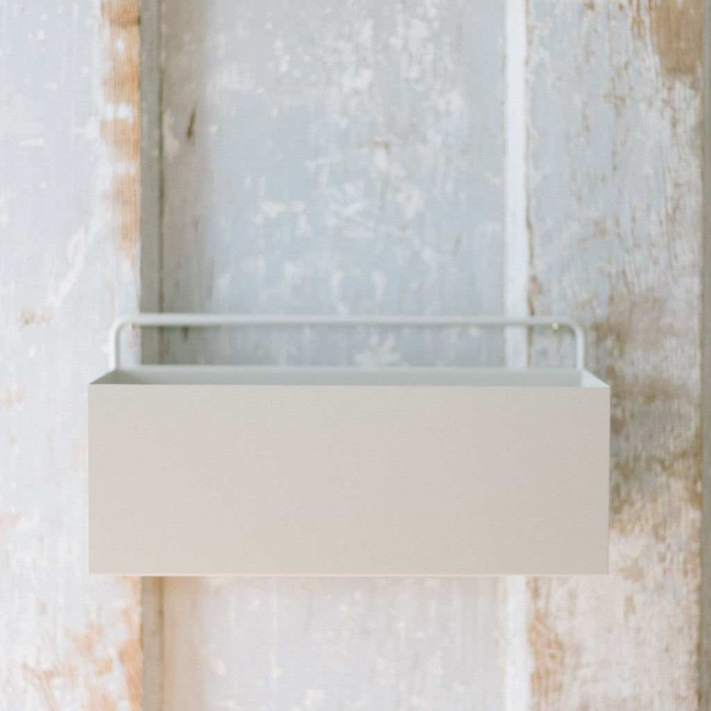 An empty white planter wall box