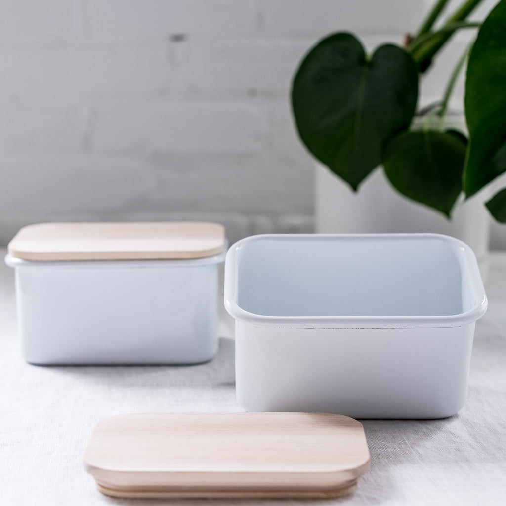 two enamel storage containers with acacia wood lids