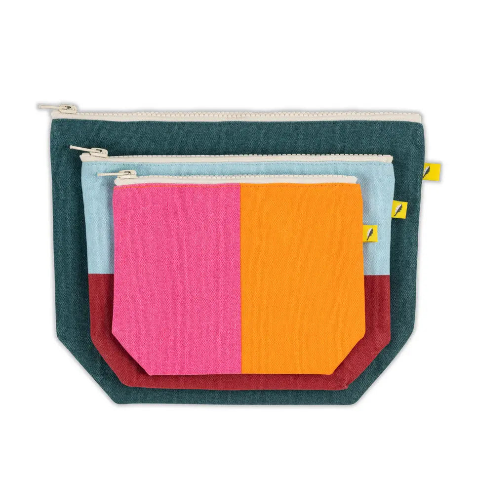 Set of colorful fabric pouches with zippers on a white background