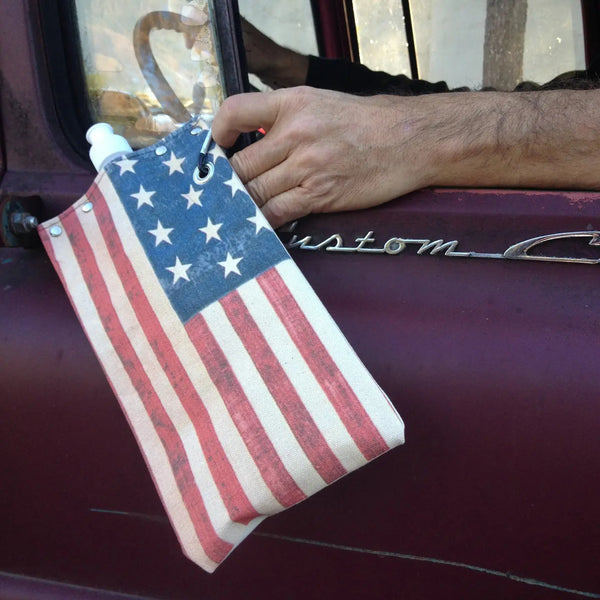 American flag canteen attached to a vehicle's door handle.