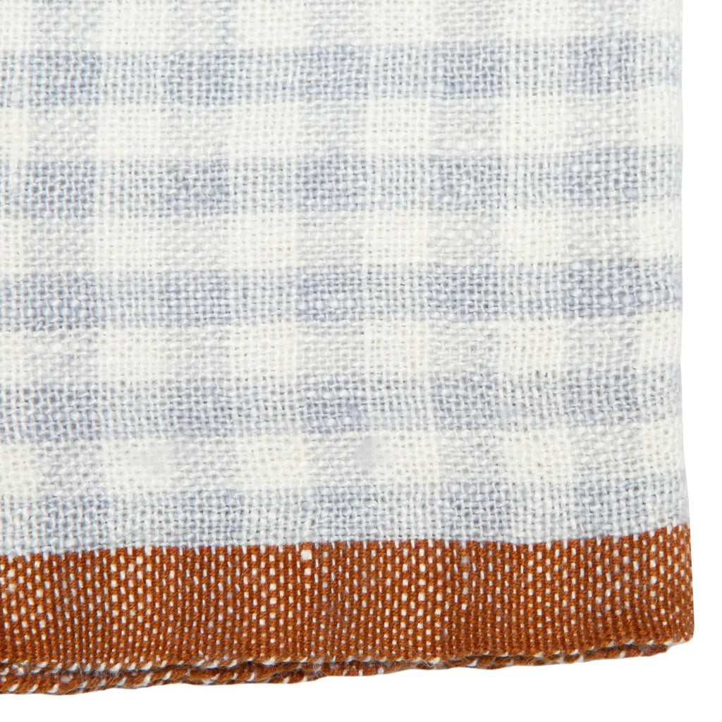 Close-up of a fabric with a checkered pattern transitioning to a solid color.