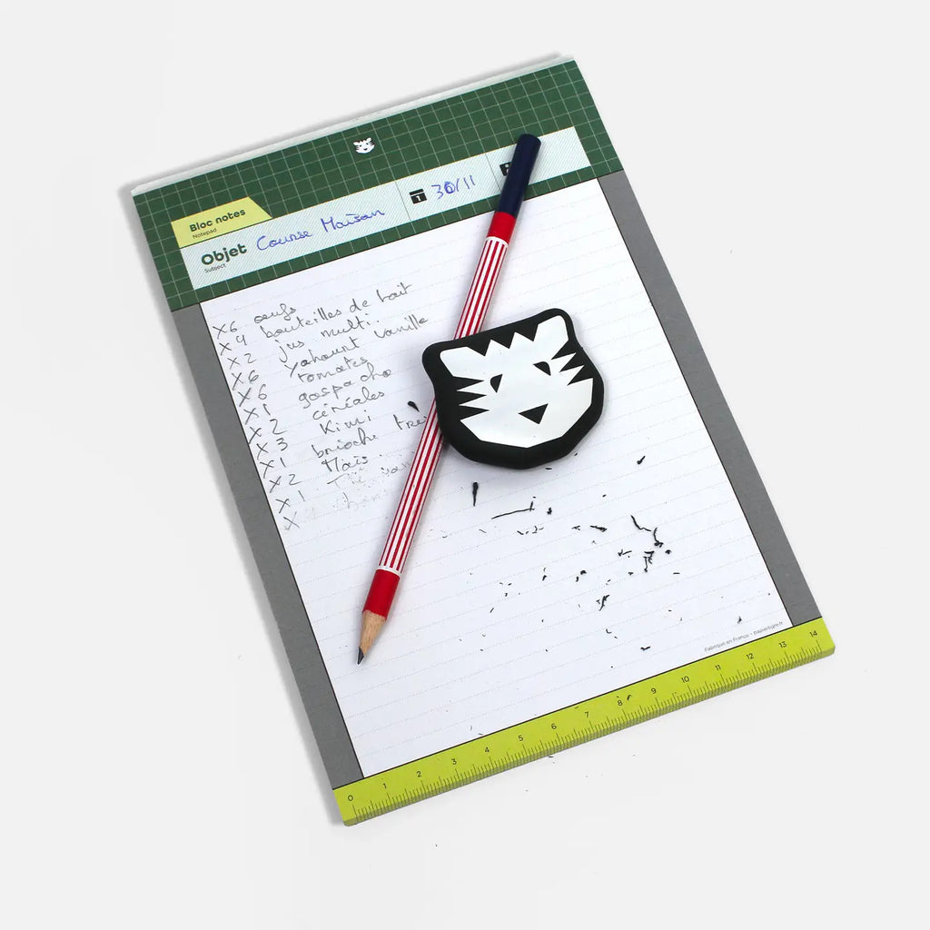 Notebook with a pen, eraser, and ruler on a white background