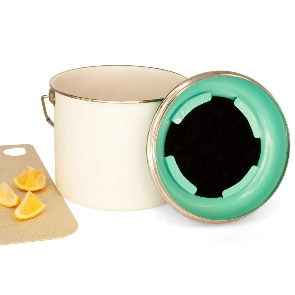 White pot with a green lid on a white background