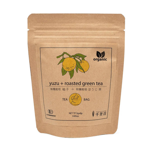 Kraft paper tea bag packaging with yuzu and roasted green tea label on a white background