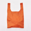 An orange reusable shopping bag with a wide top opening, shown flat against a plain white background.