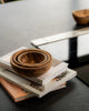 Wooden bowls on a stack of books with a blurred background