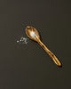 Wooden spoon with salt on a dark background