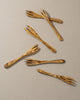 Set of wooden salad servers on a beige background