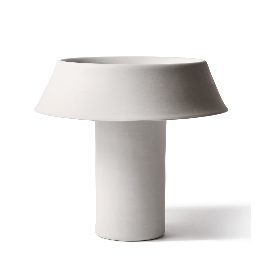 White table lamp with a cylindrical base and round shade on a white background