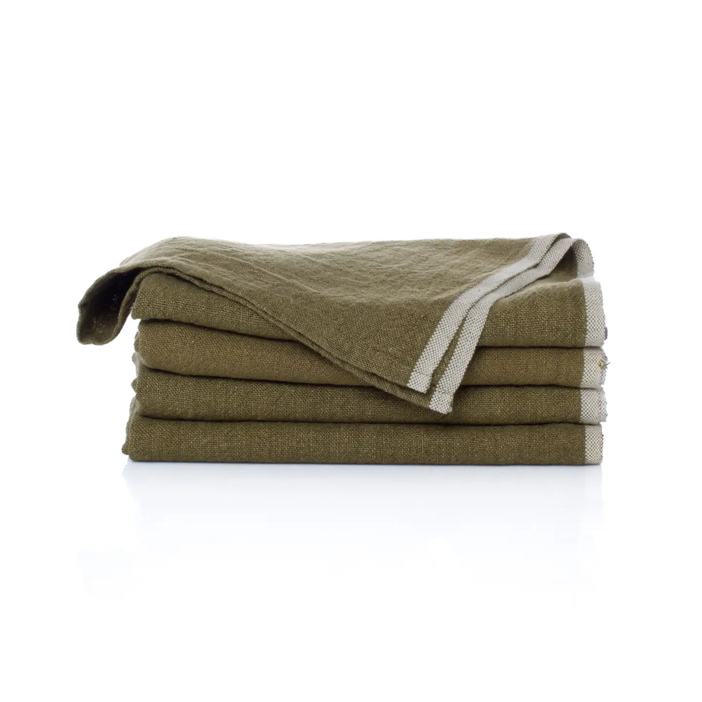 Folded green blanket with white trim on a white background