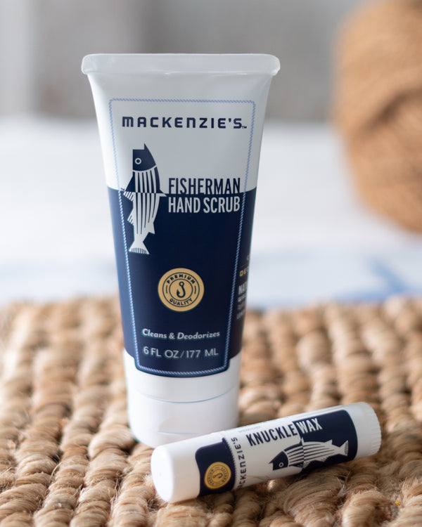 Mackenzie's Fisherman Hand Scrub tube and Knuckle Wax stick on a woven surface