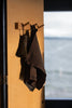 kitchen towel hanging on a wooden peg in a soft light. 