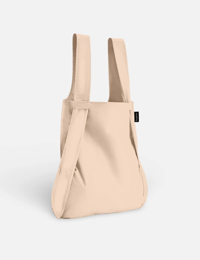 Beige backpack on a light gray background