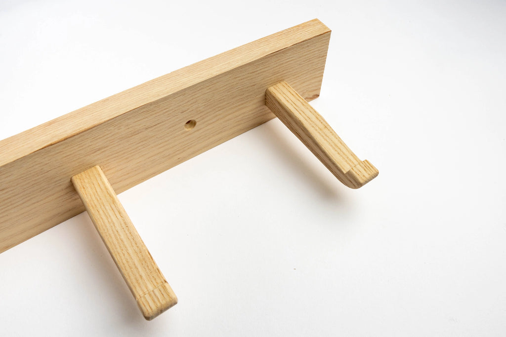 Wooden tool with two handles on a white background