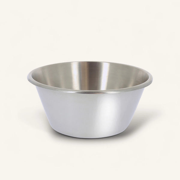 A stainless steel mixing bowl with a brushed metal finish, photographed on a clean, solid off-white background.