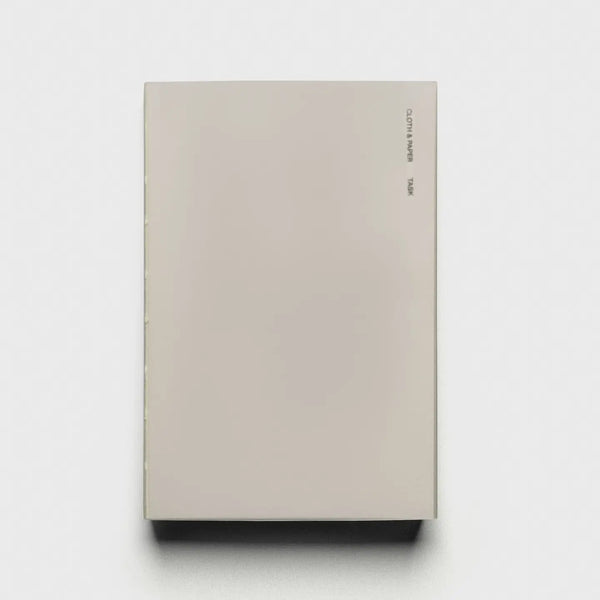 Beige notebook with 'TASK' branding on a white background