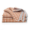 Stack of orange and white checkered towels on a white background