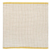 A square linen napkin featuring a beige and white gingham check pattern with a solid mustard yellow border.