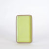 Rectangular ceramic dish with a light green interior on a white background