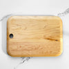 Wooden cutting board on a marble surface