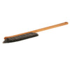 Brush with wooden handle and black bristles on a white background
