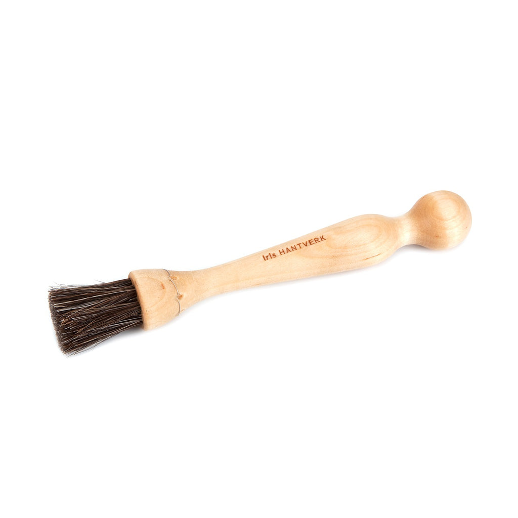 Wooden brush with bristle head on a white background