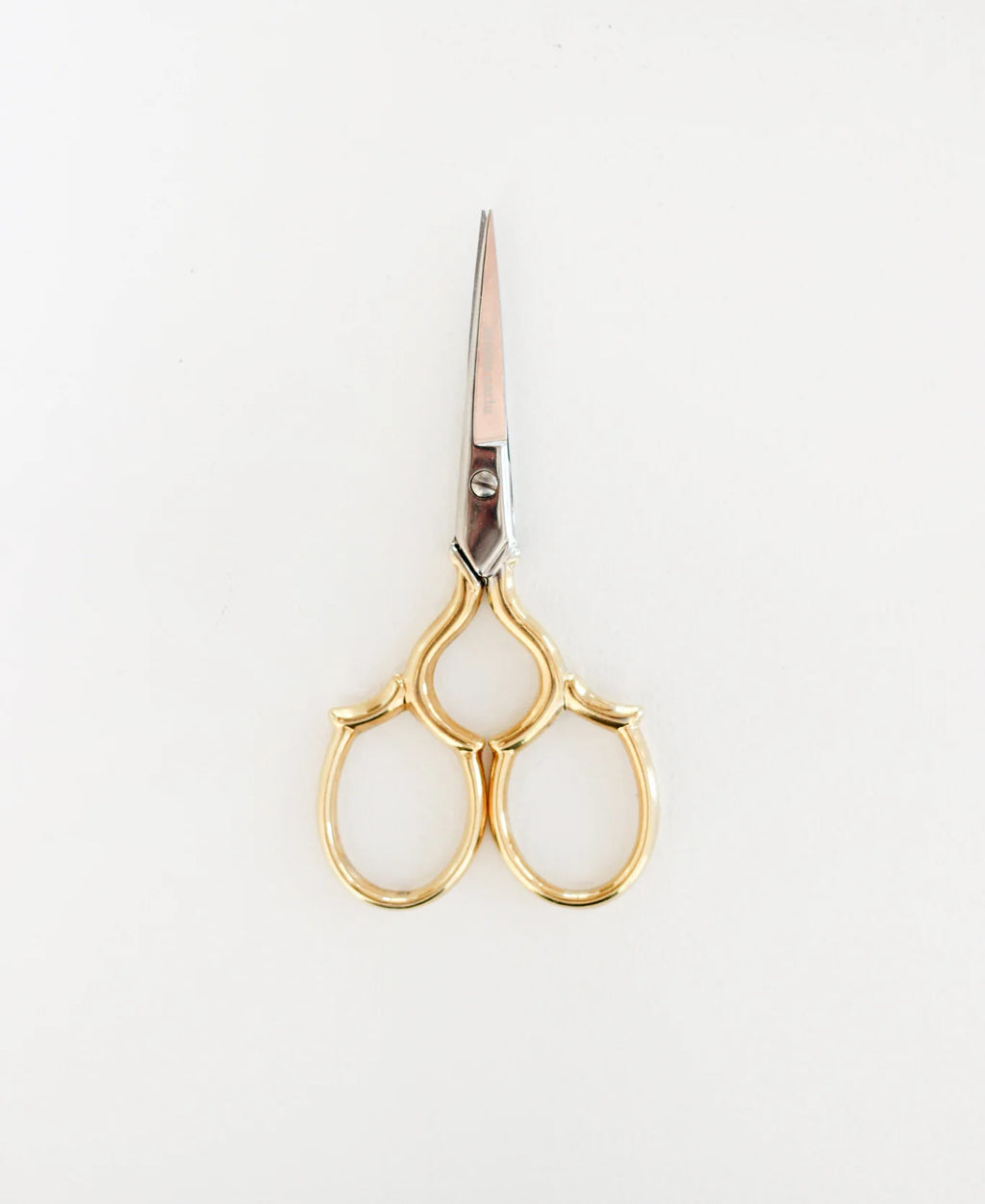 Gold-handled scissors on a white background