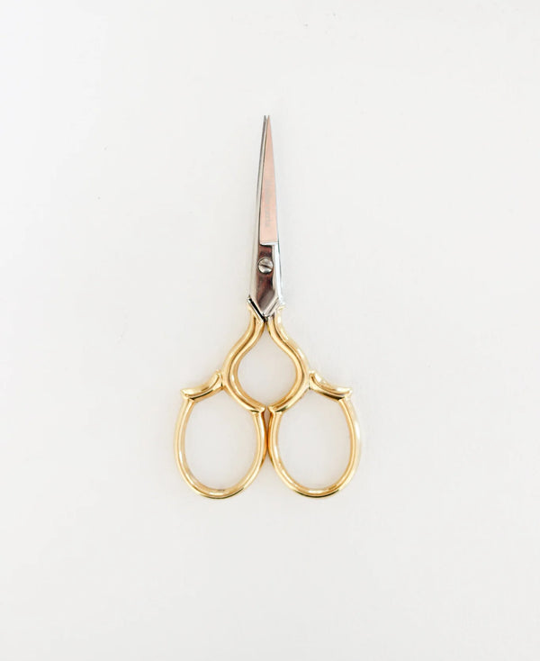 Gold-handled scissors on a white background