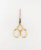 Gold-handled scissors on a white background