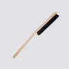 Duster with black bristles on a light gray background