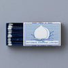 Indigo match box with a peach on the front.