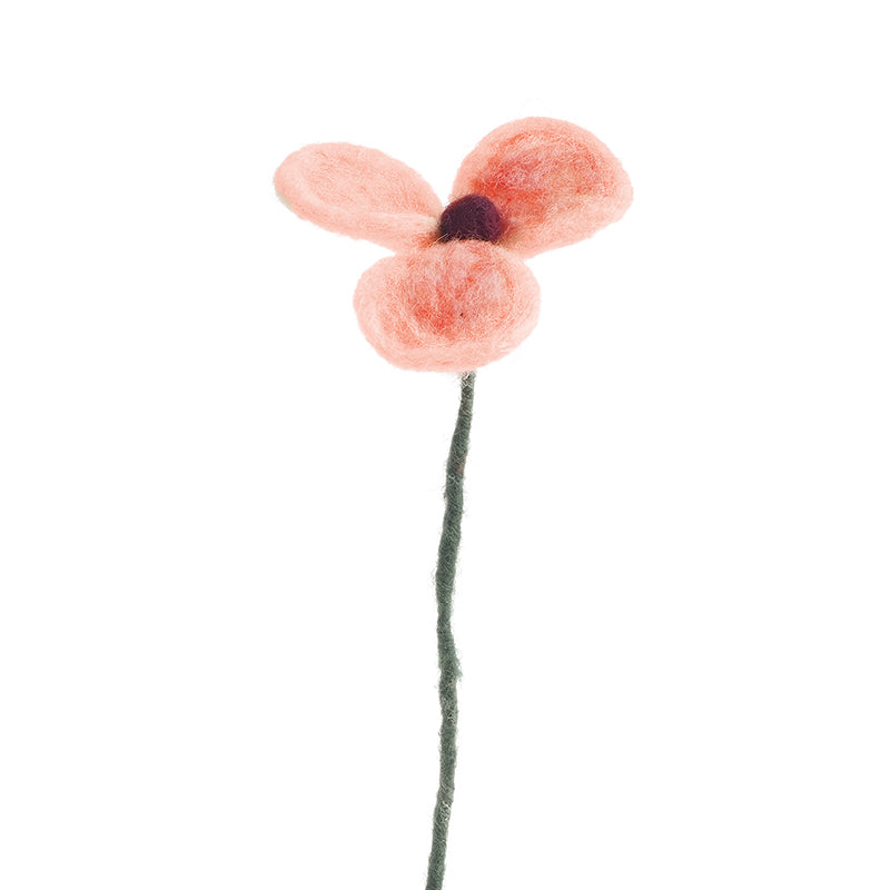Felted pink flower on a white background