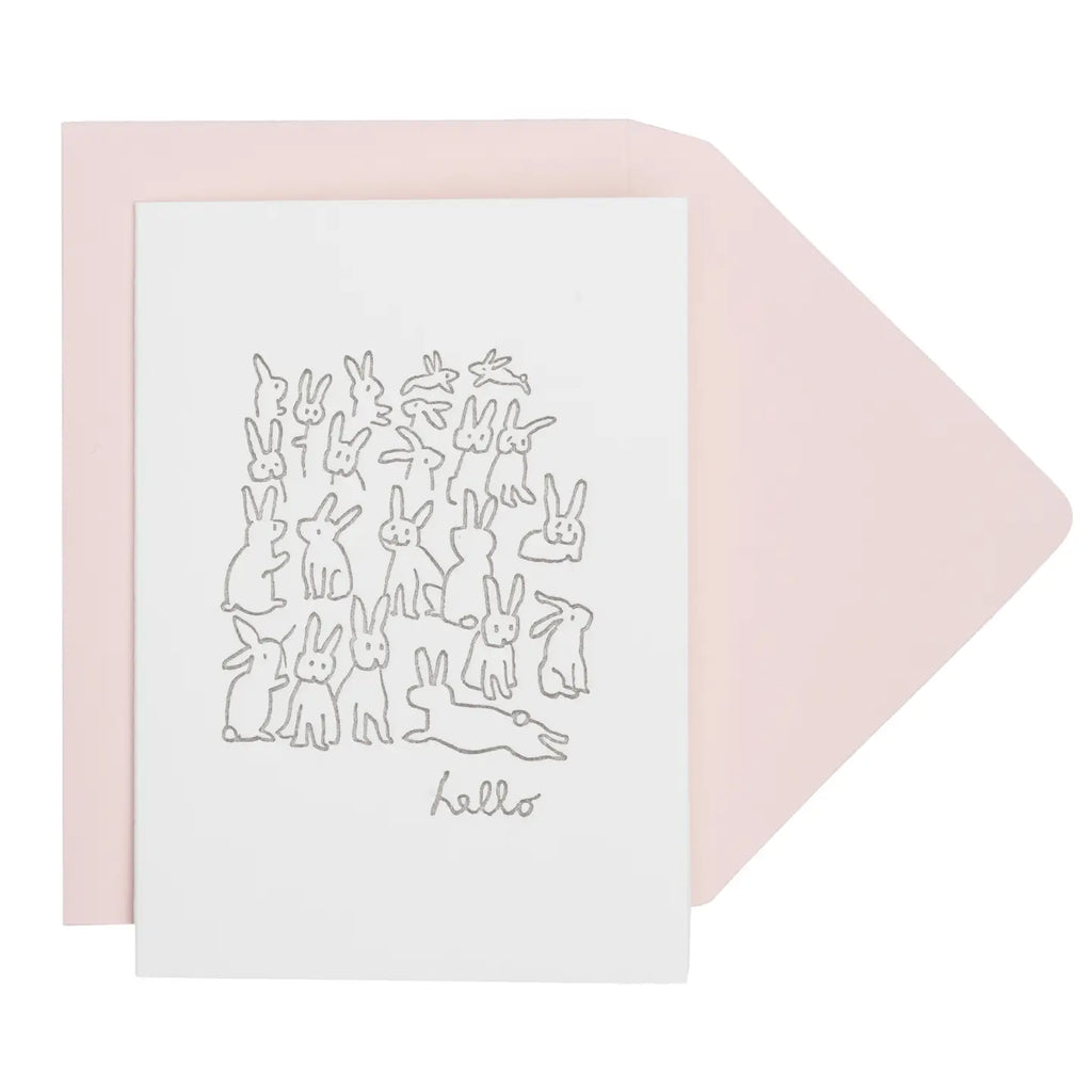 Greeting card with rabbit illustrations and 'hello' text, paired with a pink envelope on a white background.
