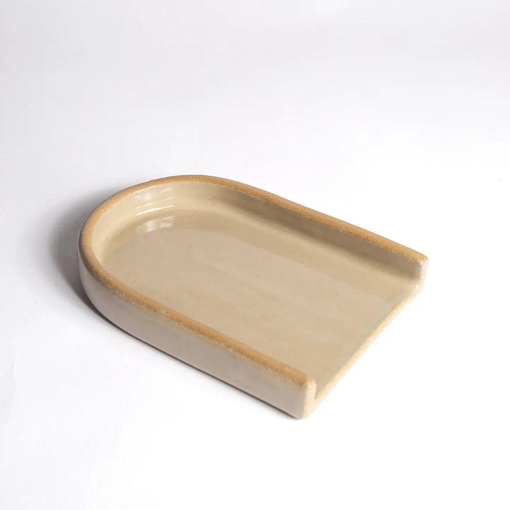 Beige ceramic dish on a white background