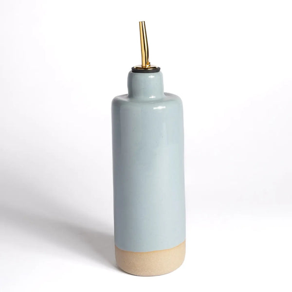Ceramic bottle with a gold cap on a white background