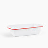 Rectangular white baking dish with red rim on a white background