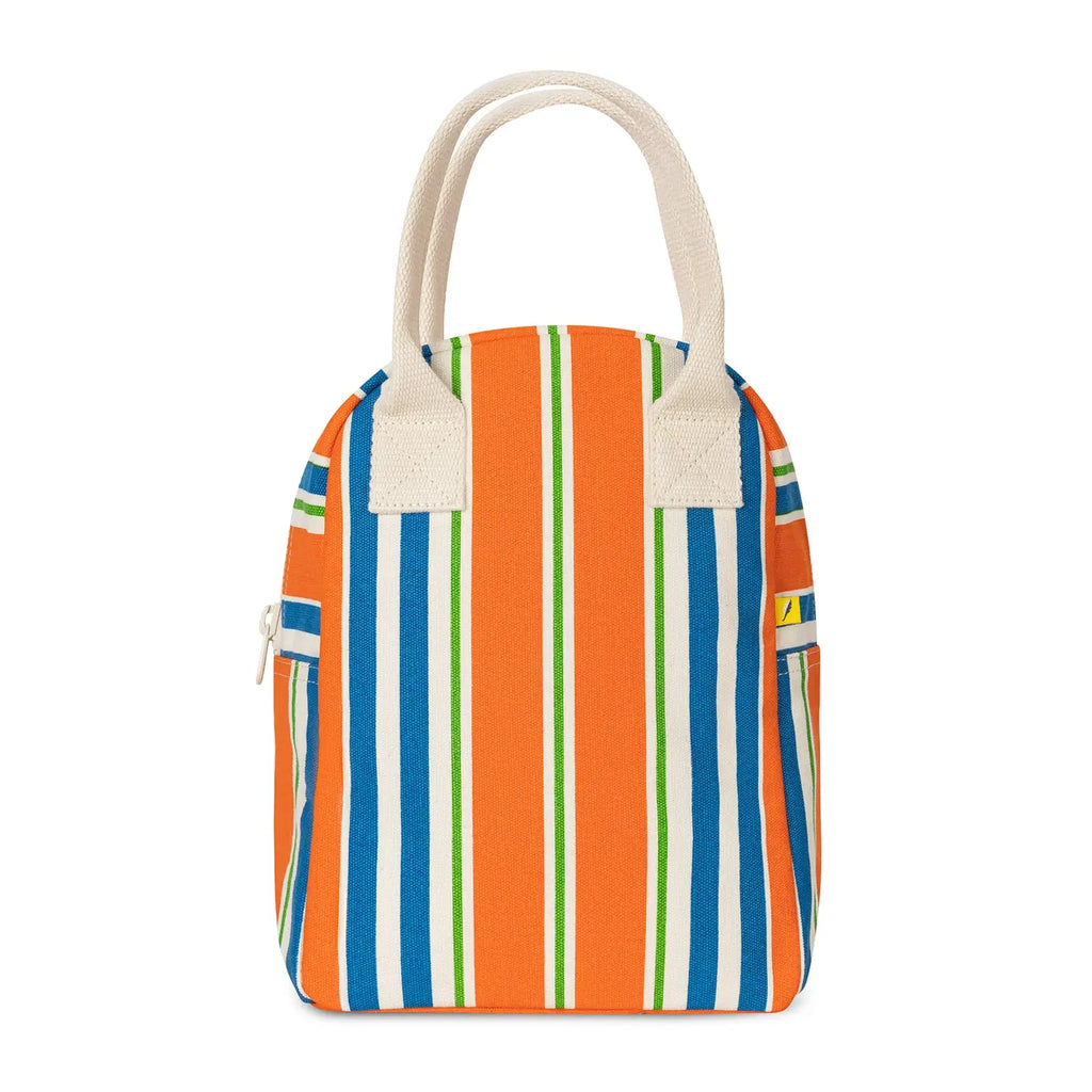 A striped canvas lunch bag with vertical orange, blue, green, and white stripes, featuring cream-colored fabric handles and side pockets.